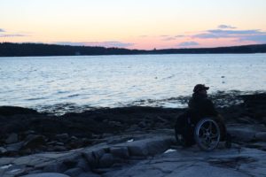 Enock on the beach watching sunset at Schoodic Point Acadia