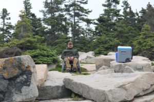 Enock sitting on rocks