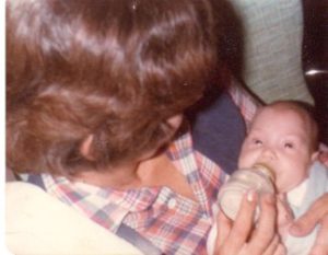 Mom holding enock feeding him